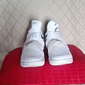 White Nike Lebron Soldier 12 With Laces Up Straps That Have Velcro.